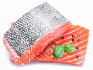 Fresh raw salmon fillets decorated with green basil.