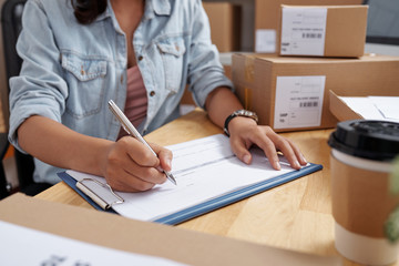 Cropped image of delivery service manager filling document