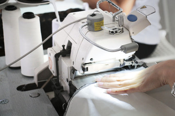 working with sewing machine on the edge of a piece of fabric