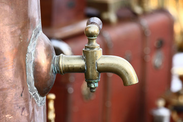 Samovar crane./Water brass crane of a copper antiquarian samovar close up.