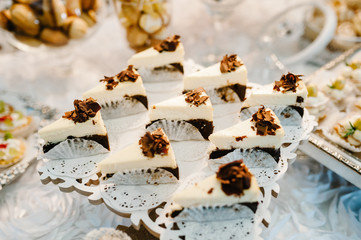 Plate with cakes decorated dessert table for a party. Delicious sweets on buffet. Table with muffins, candy for a party goodies on wedding banquet area. Close up. candy bar. flat lay. top view.