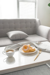 Classic donut. Morning breakfast on table in living room at home.