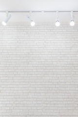 Ceiling light on white brick wall texture background with copyspace.