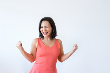 Fototapeta premium Happy attractive Caucasian woman clenching fists as symbol of success. Pretty middle aged woman gesturing with closed eyes. Celebrating success concept.