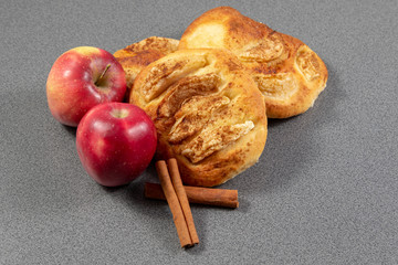 Apple and cinnamon sticks beside apple pie