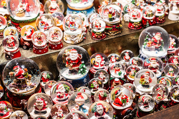 Traditional Souvenirs snow globes and toys Santa Claus Dolls At European Winter Christmas Market Souvenir