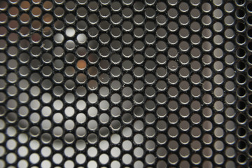 the texture of a shallow metal mesh that covers the speakers