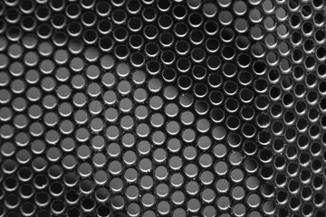 the texture of a shallow metal mesh that covers the speakers
