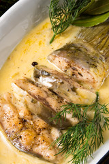 fried christmas carp in butter sauce with dill and lemon