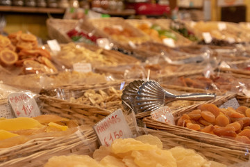 colorful fresh dried fruits and vegitables lined up and sold in food market in italy