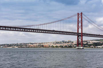 Fototapeta na wymiar The 25 de Abril Bridge over the River Tagus in Lisbon, Portugal