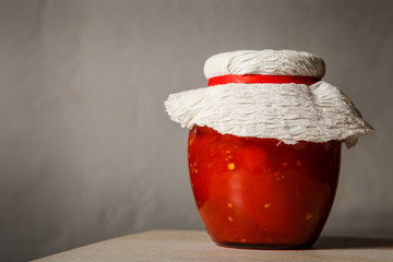one big glass jar with homemade canned tomatoes