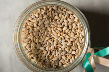 wheat seeds in glass jar on table