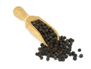 Black pepper on wooden scoop isolated on white background
