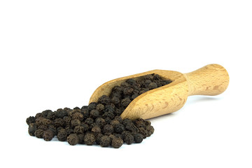 Black pepper on wooden scoop isolated on white background