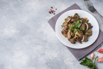 Baked chicken liver with onion on a plate