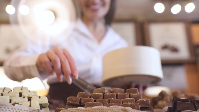 Chocolate Store. Female Seller In Confectionery Shop