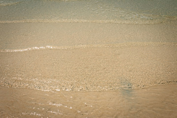 droped sungrass and small waves lapped the beach