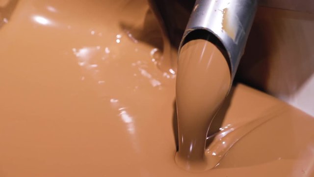 Chocolate Production At Factory. Melted Chocolate Closeup