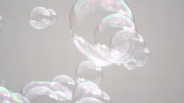 Abstract white background with soap bubbles, pubblic entertainment. Slow motion