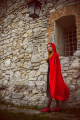 Halloween party concept, mysterious girl in black lace handmade dress and red hood. Beautiful young woman. Inspiration for halloween celebration, ideas and simple nice detail  