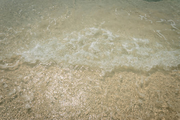 droped sungrass and small waves lapped the beach