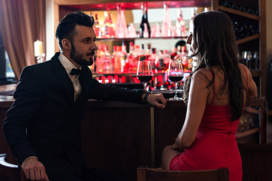 Handsome couple of lovers flirting in the pub and drinking red wine. Stock  Photo | Adobe Stock