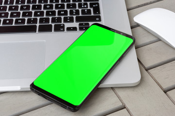 Modern smartphone on a laptop close-up