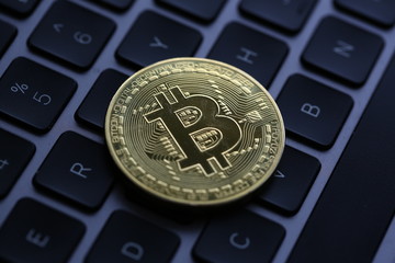 Coin crypto currency bitcoin lies on the keyboard
