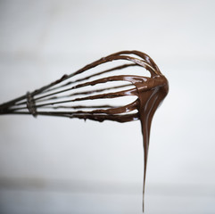 Chocolate sauce on a whisk