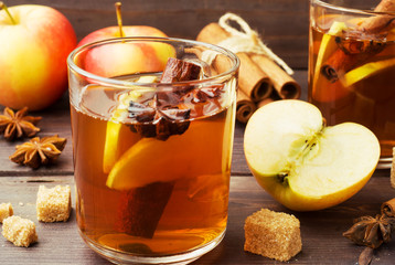 Mulled wine cider in glass mugs with cinnamon, anise and apples. The concept of the cocktail bar.