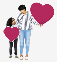 Obraz na płótnie Canvas Happy mother and son holding heart icons