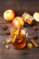Mulled wine cider in glass mugs with cinnamon, anise and apples. The concept of the cocktail bar.