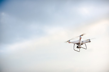 UAV drone copter flying with digital camera.Drone with high resolution digital camera. Flying camera take a photo and video.The drone with professional camera takes pictures of the misty mountains.