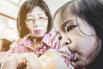 Asian children with Grandmother in airplane flight