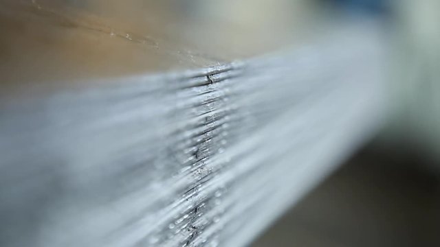 Metal sheets. Metal sheets are put by a pile. It is removed through refocus. Sheets are removed in section. Color of sheets steel.