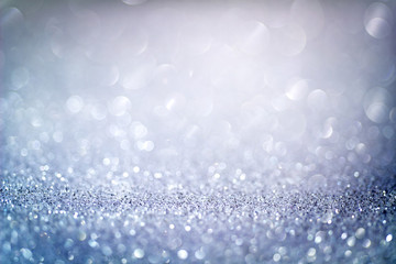 Abstract blue glitter bokeh background with shimmering light bubbles