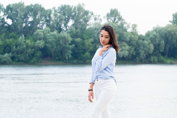 Beautiful Asian brunette woman near the river in nature