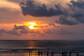 Bali sunset with people on beach