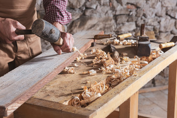 Woodworker using chisel to smooth down wood