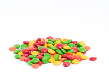 Creative arrangement of colorful candies and sweets on white background