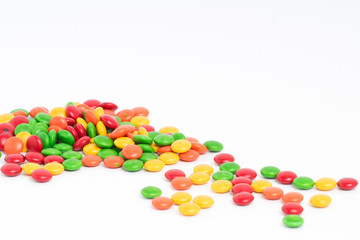 Creative arrangement of colorful candies and sweets on white background