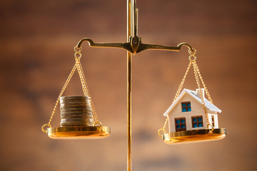 Stacked Coins And House Model Balancing On Justice Scale