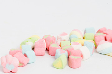 Creative arrangement of colorful candies and sweets on white background