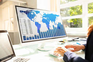 Businesswoman Analyzing Graphs On Computer