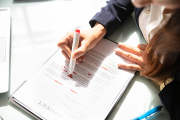 Businesswoman Marking Error In Contract Form