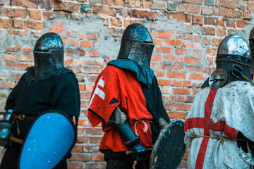 Three medieval knights in armor.