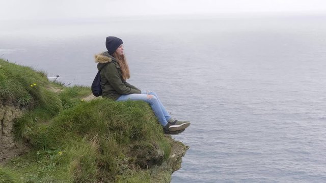 Pretty girl its on the edge of the Cliffs of Moher