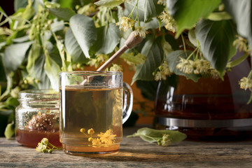 Glass of linden tea with honey  on wooden table.