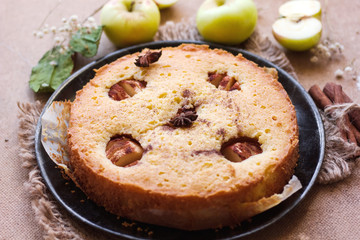 Apple cinnamon cake, cinnamon sticks, apples on the table